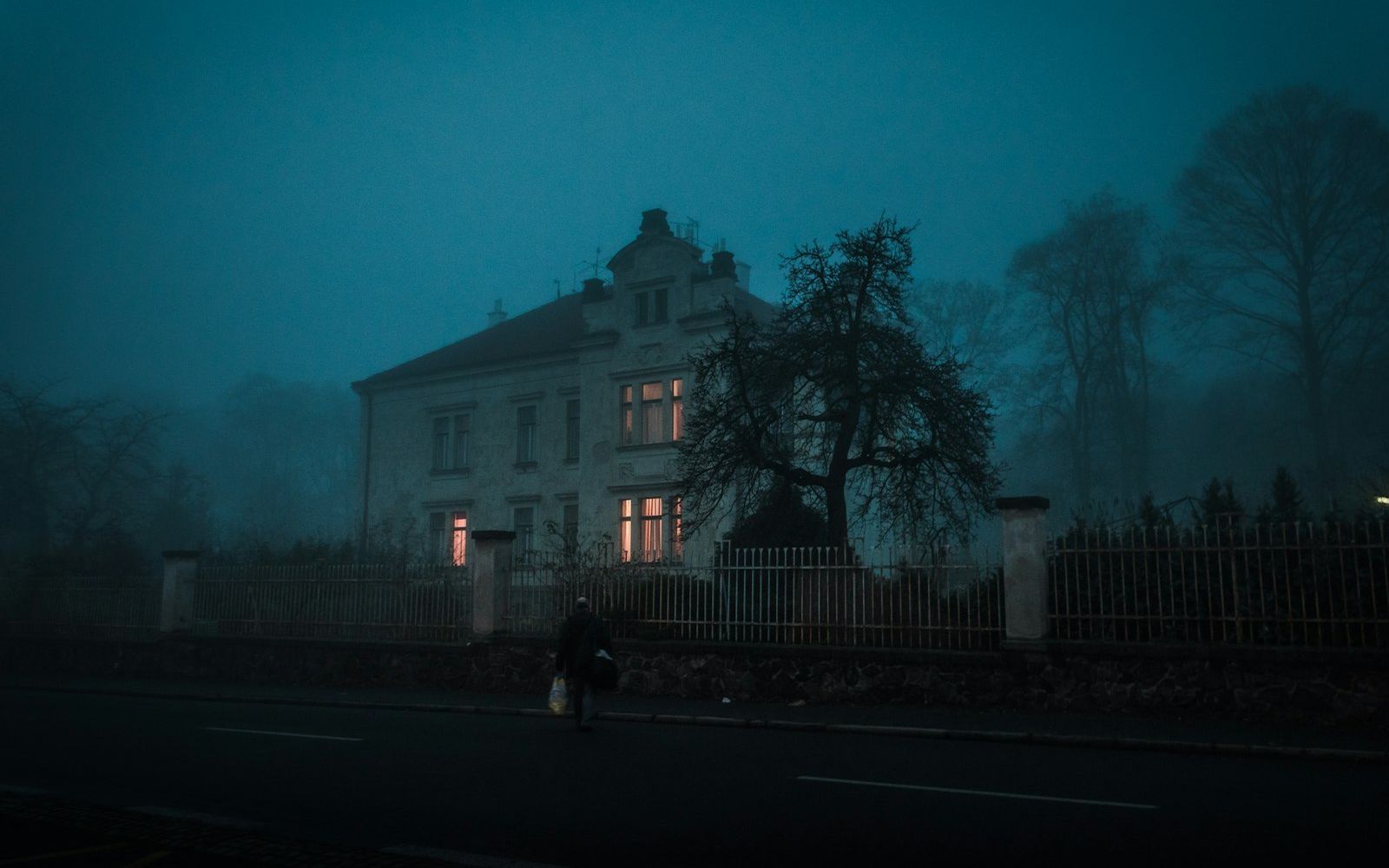 An old house in thick night fog