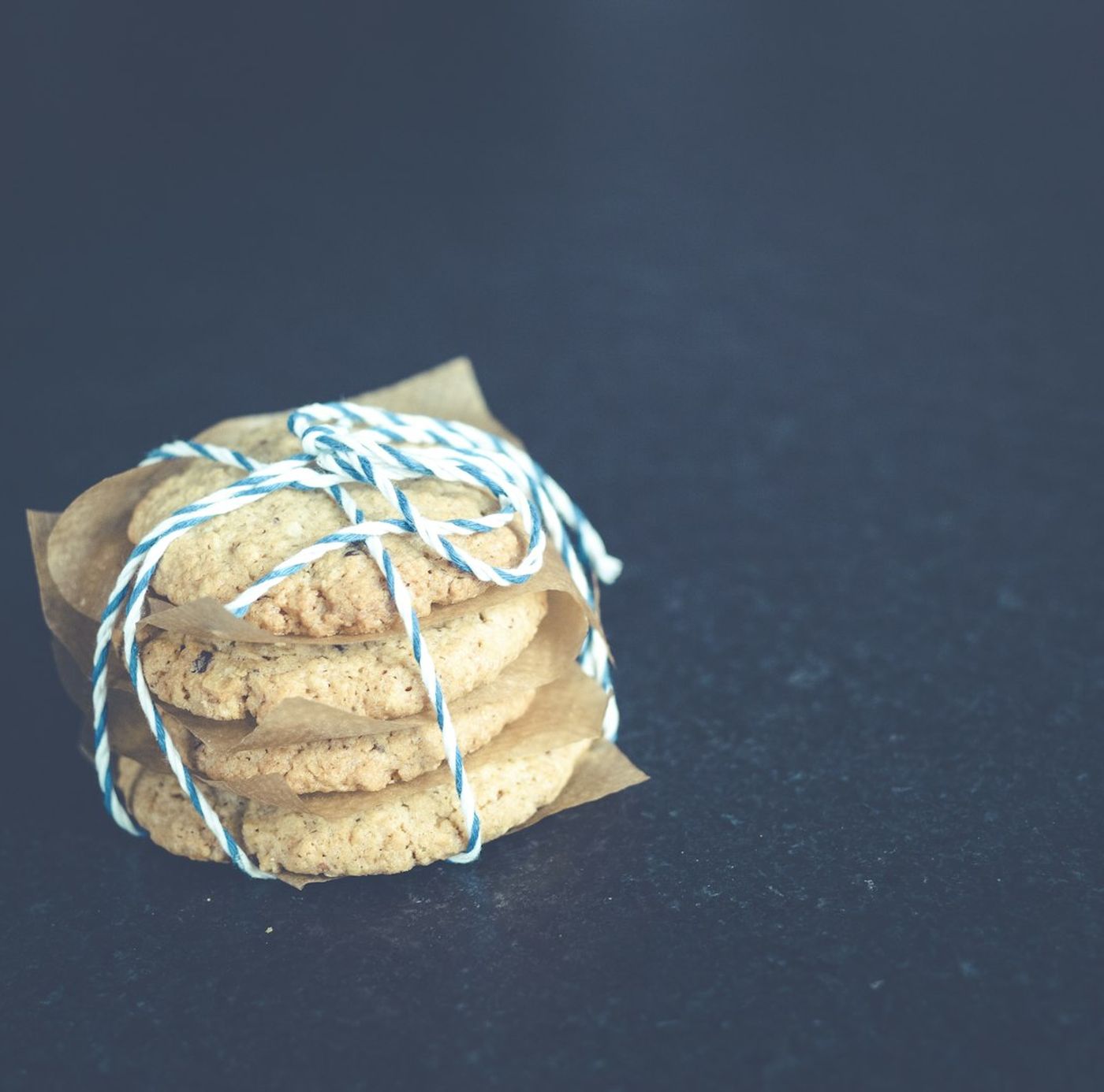 A clear bag of cookies tied with a checked ribbon