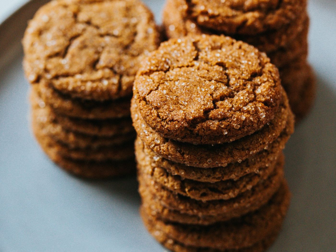 Two stacks of caramel coconut cookies topped with caramel squares