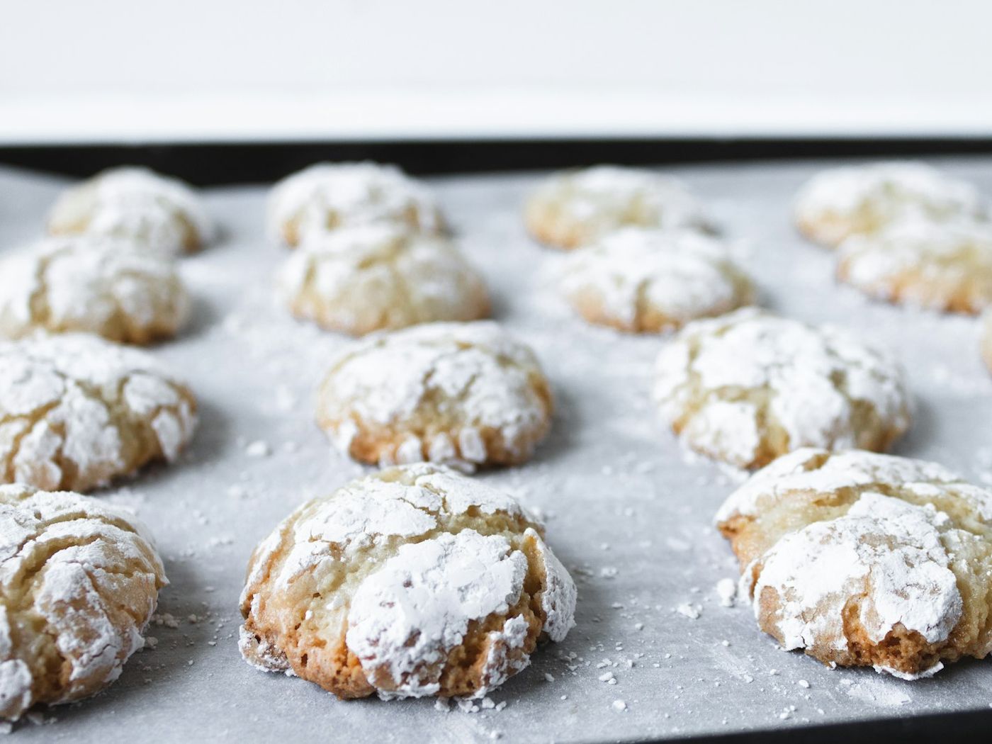 Six lemon and white chocolate cookies on parchment