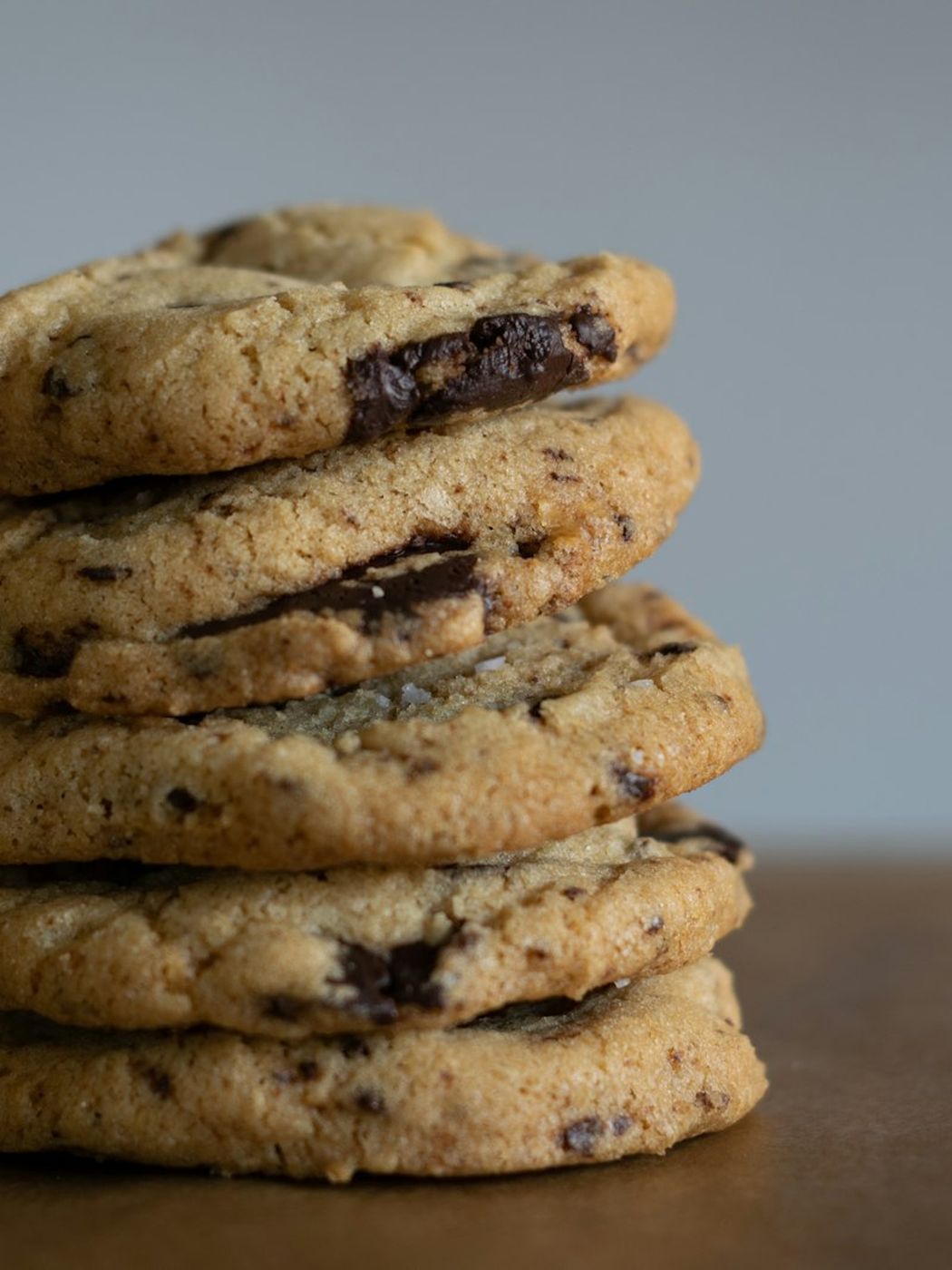 A tall stack of walnut cookies cooling on a wire rack