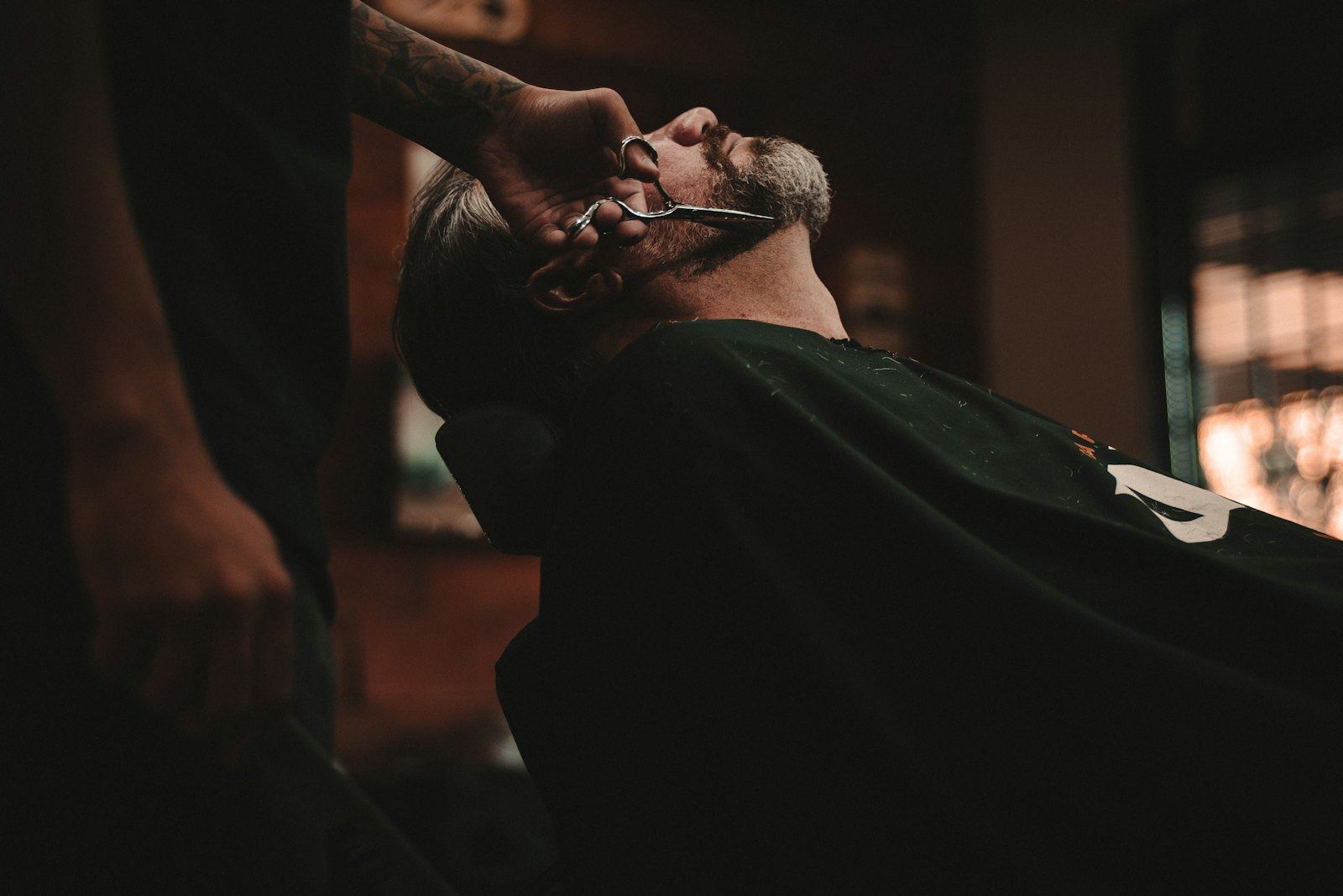 A man reclined for a hot shave