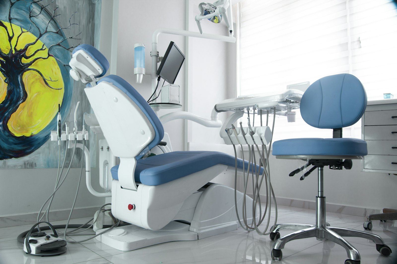 A treatment chair beside a colorful painting