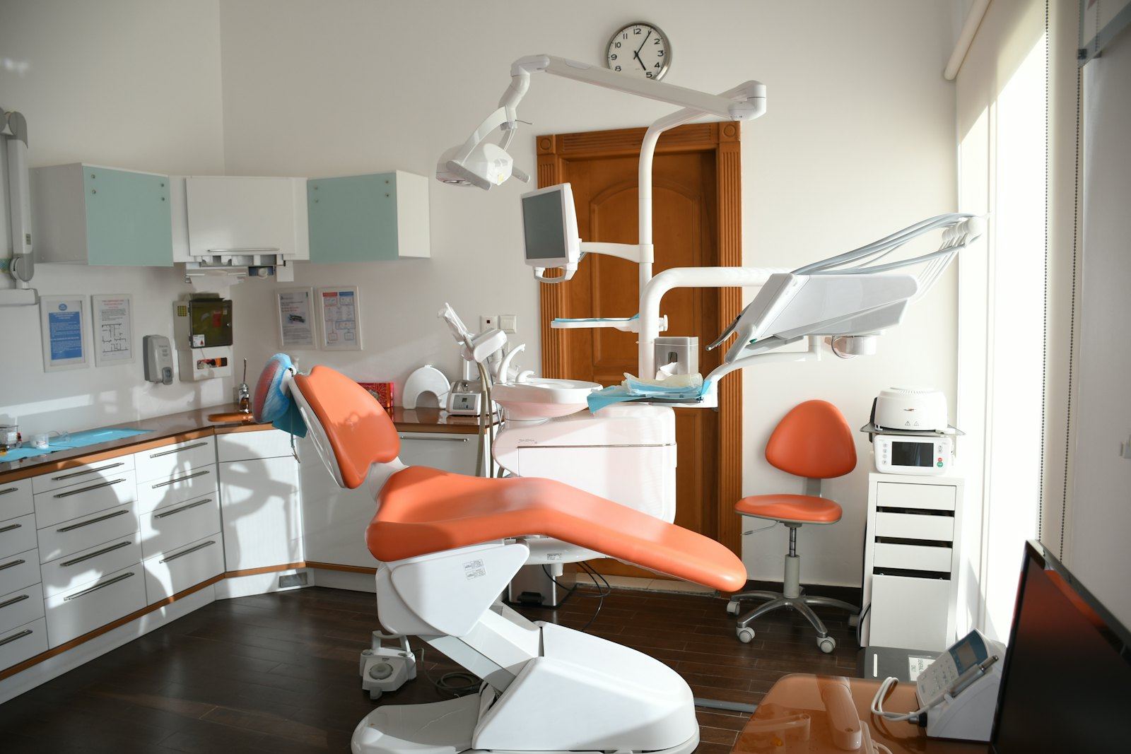 A treatment room with an orange chair