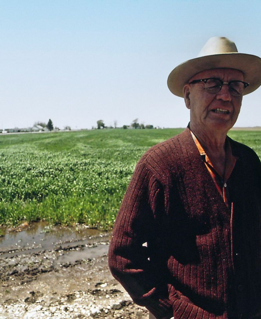 A farmer at the edge of a field