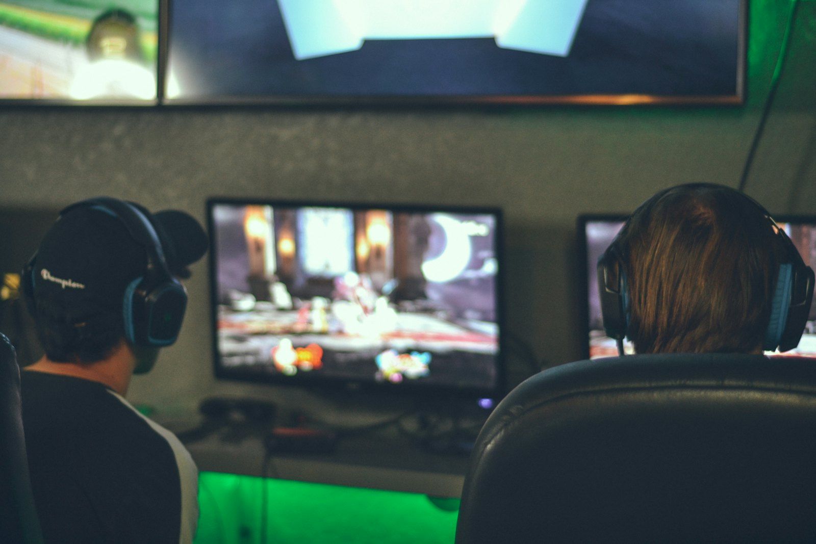 Players in headsets in front of monitors