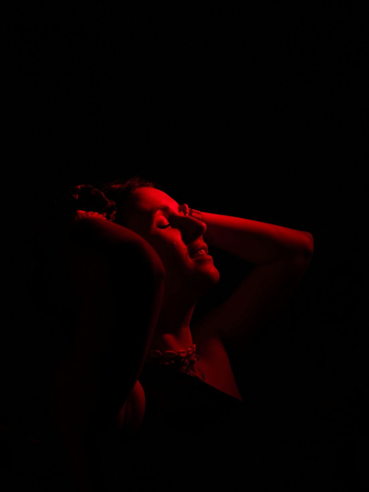 A figure lit in red