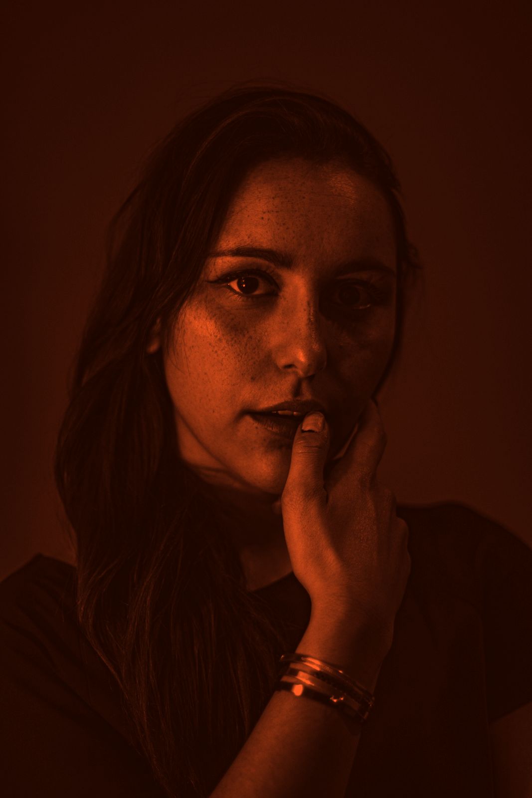 A faculty portrait in orange duotone