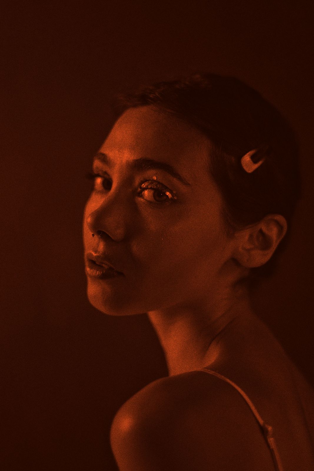A faculty portrait in orange duotone