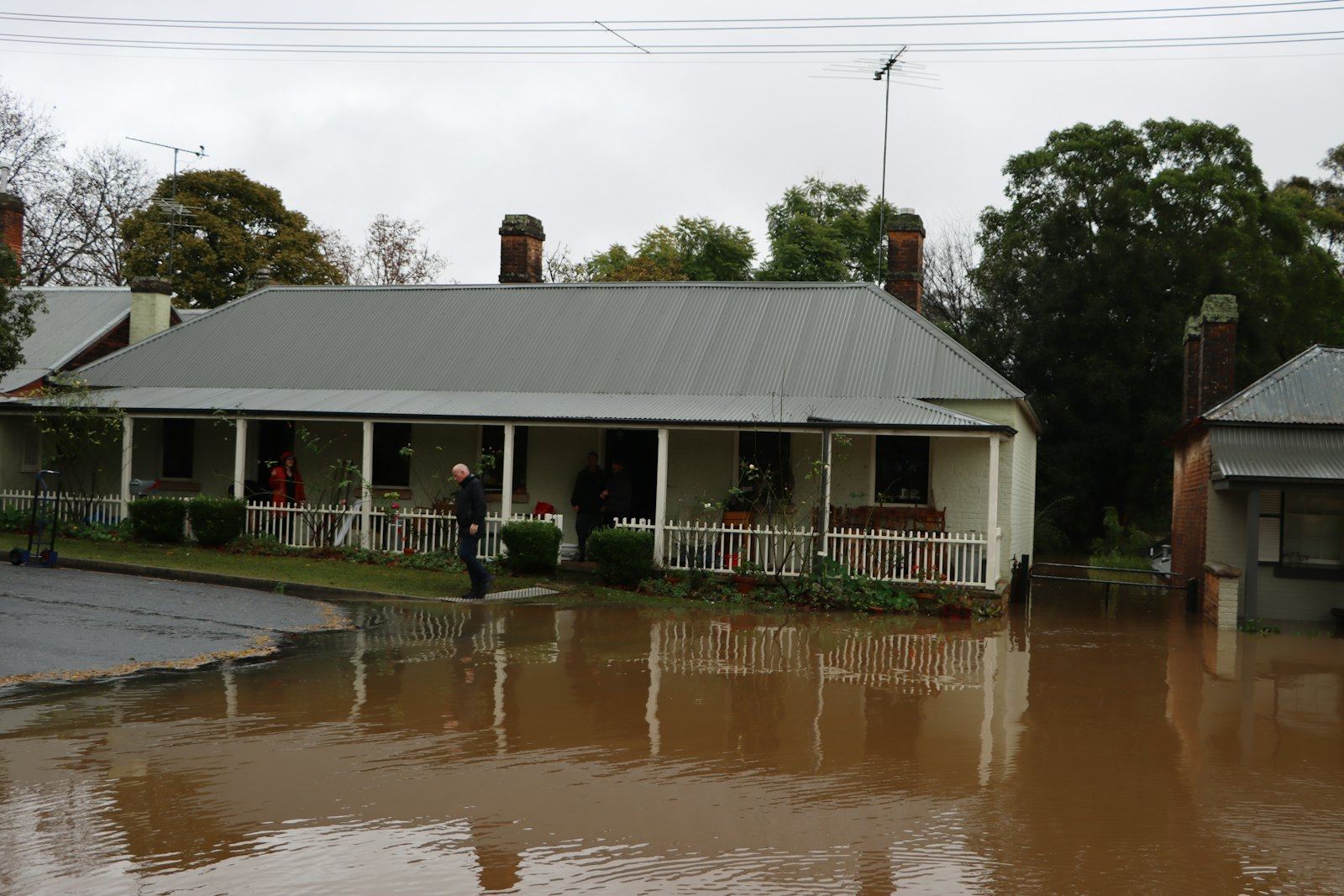 A house and its street under floodwater