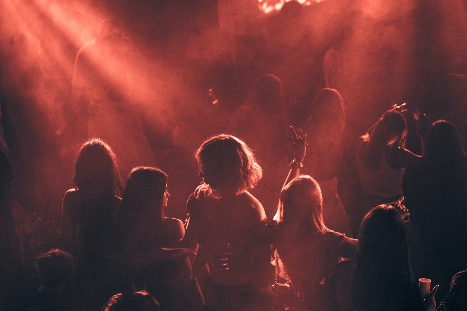 A dancing crowd in red smoke