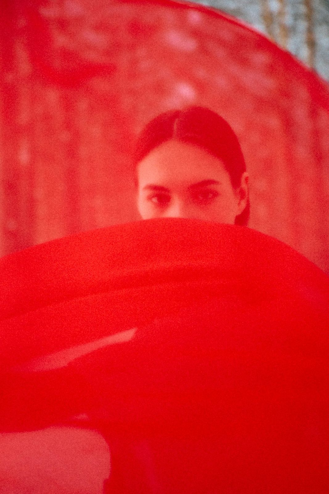 A face half-hidden in red