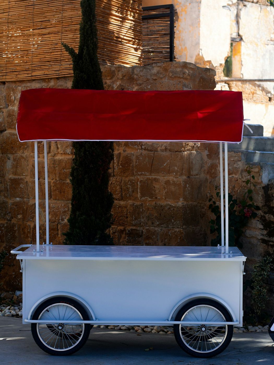 A white wooden market stall stocked with bagged cookies